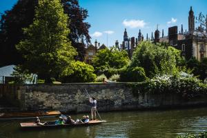 A group of people riding on the river by Trinity Hall Cambridge - by Chris Boland