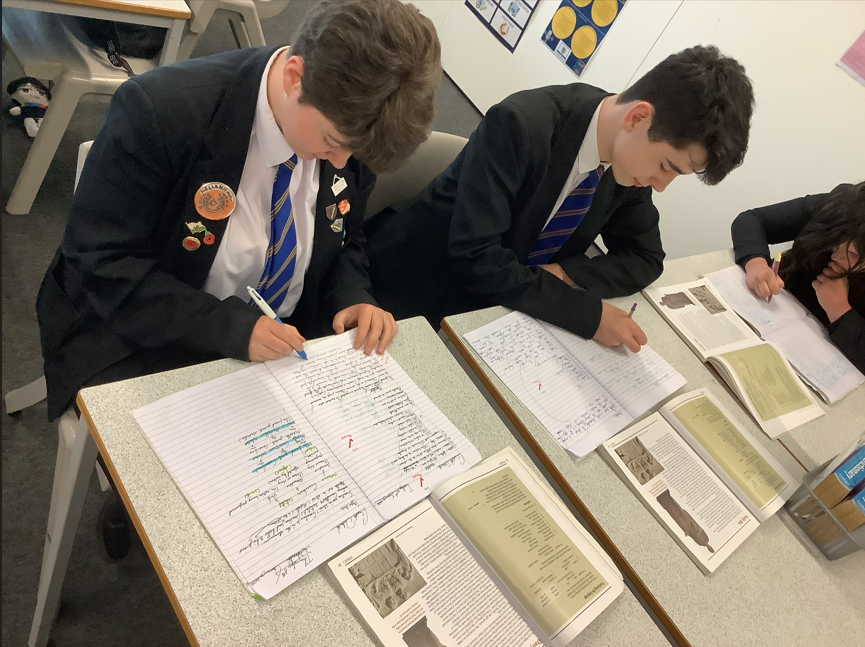 two pupils at Caldicot sit at their desk learning Latin