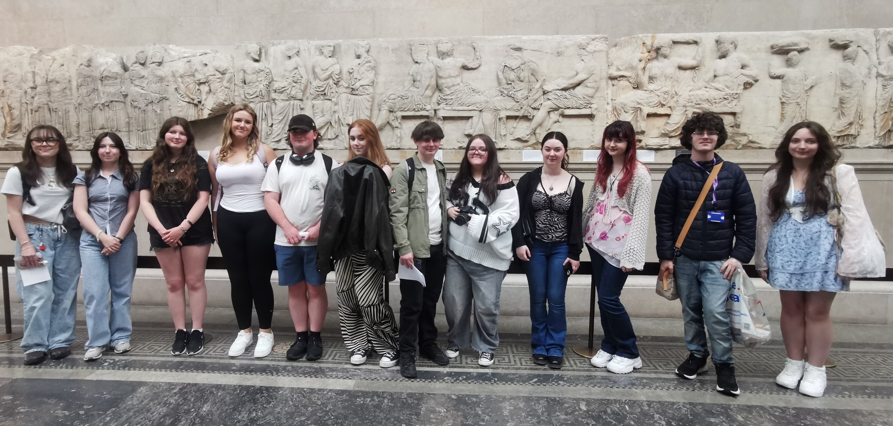 Students from Carmel College standing in front of a Parthenon frieze