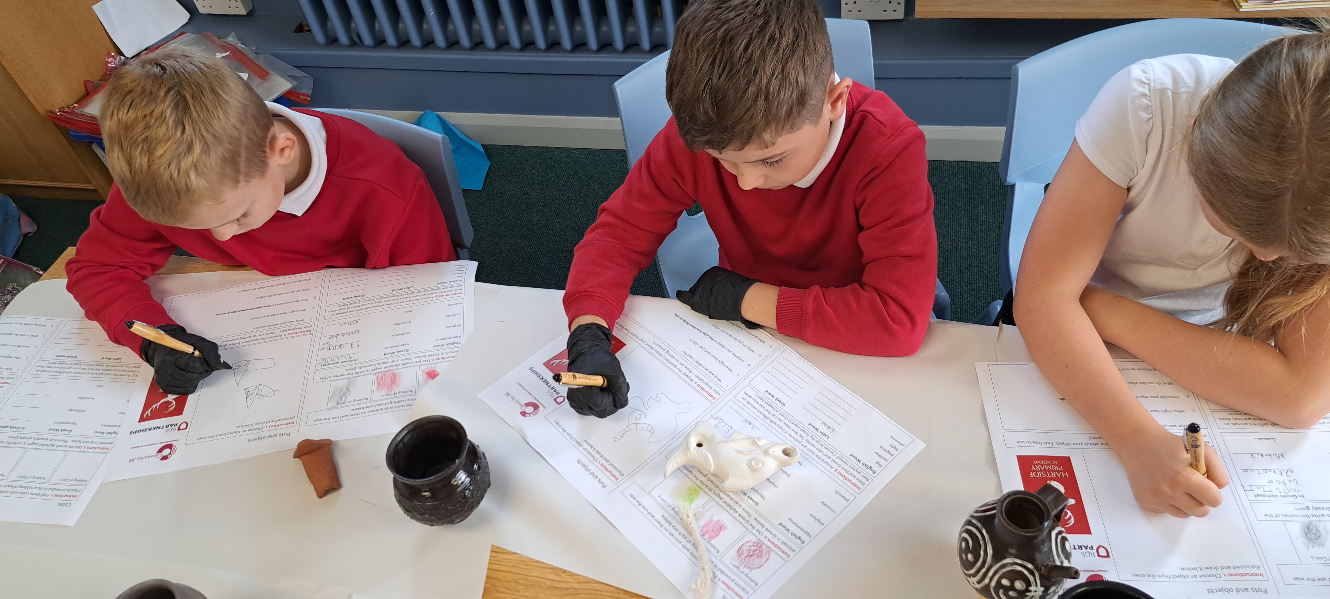 Pupils at Hartside primary using a handling box